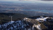 Wind turbine on a snow capped mountain
